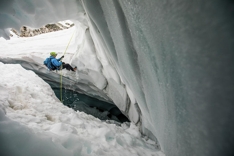 Mountaineer Rappels Into Glacier Cave. Photograph by Cavan Images ...