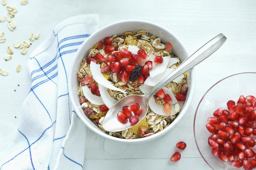 Muesli With Milk, Oats, Cereals, Chia Seeds, Pomegranate Seeds, Grated Coconut And Cranberries Photograph by Achim Sass