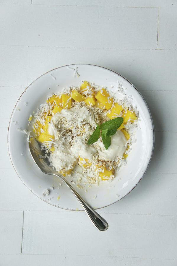 Muesli With Oatmeal, Coconut Cream, Dessicated Coconut, Mango And Lemon Balm Photograph by Martina Schindler