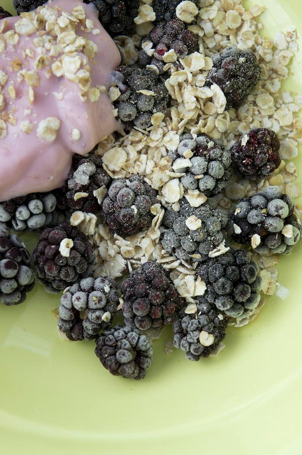 Muesli With Oatmeal, Frozen Blackberries And Yoghurt Made From Coconut Milk Photograph by Martina Schindler