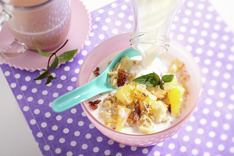 Muesli With Oats, Pineapple, Apple, Oranges, Persimmon And Milk Photograph by Teubner Foodfoto