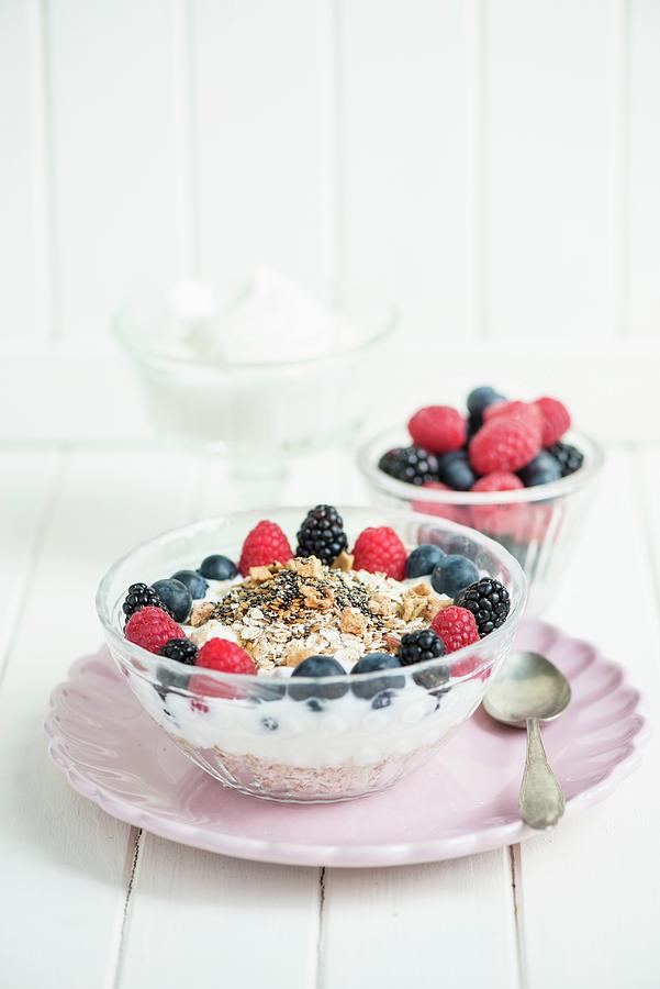 Muesli With Yoghurt, Chia Seeds, Dried Fruit And Berries Photograph by Fotografie-lucie-eisenmann
