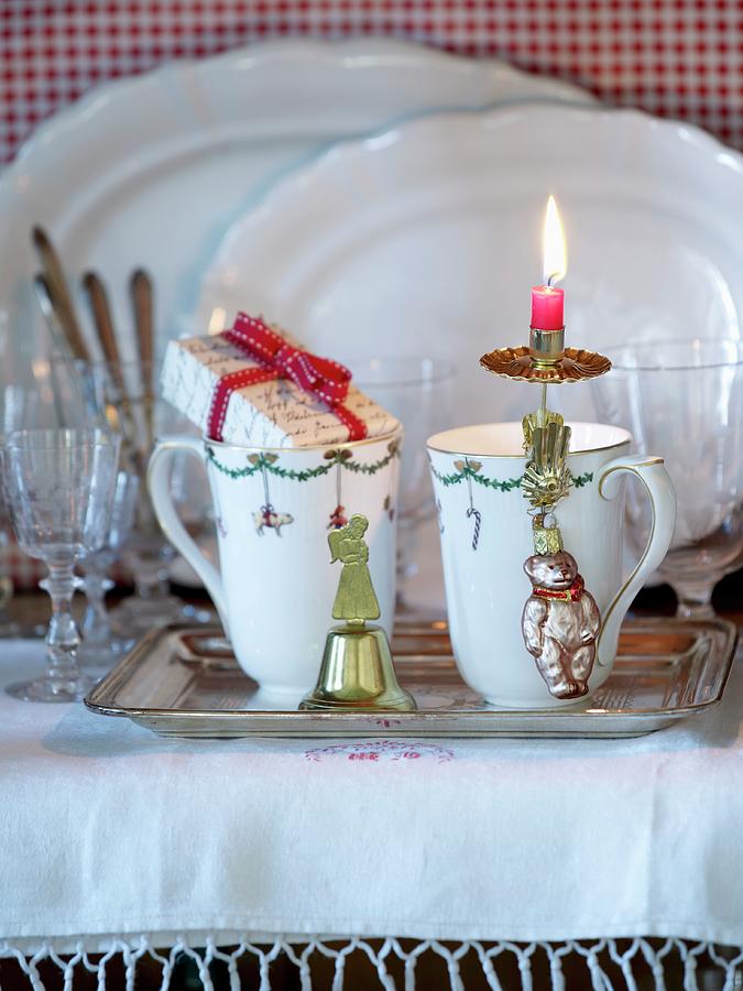 Mugs With Christmas Decorations On Silver Tray In Front Of Glasses And White Porcelain Dishes Photograph by Matteo Manduzio