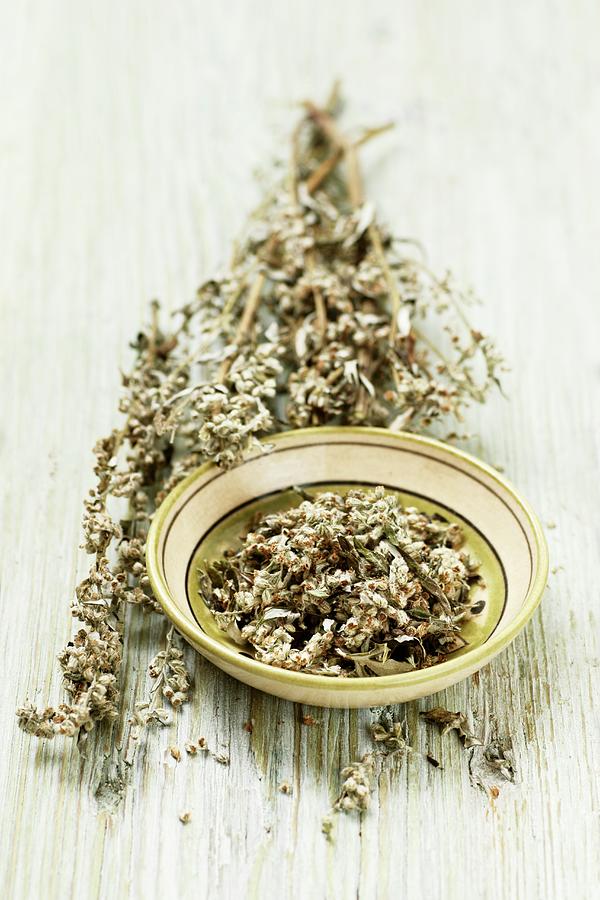 Mugwort With Flowers In A Bowl And On A Wooden Surface Photograph by Petr Gross