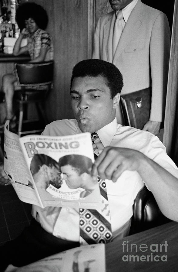 Muhammad Ali Reading A Magazine Photograph by Bettmann