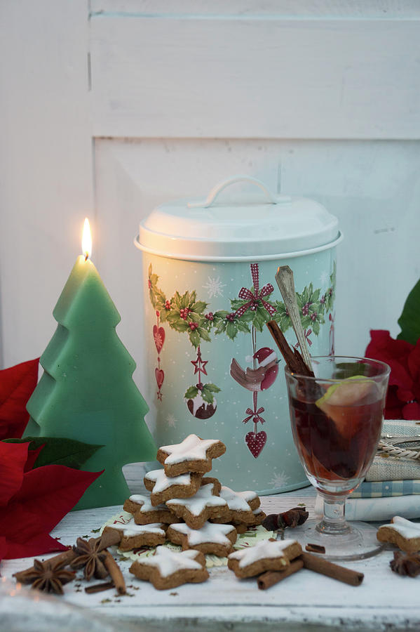 Mulled Wine, Cinnamon Stars, Poinsettias, A Christmas Tree-shaped Candle And A Tin Photograph by Martina Schindler