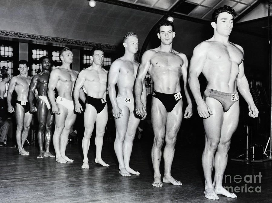 London Photograph - Muscle Men Stand On Line Mr. Universe by Bettmann
