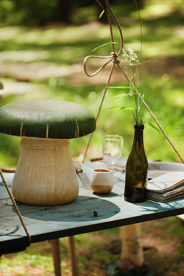 Mushroom Ornament On Suspended Table Outdoors Photograph by Colin Cooke