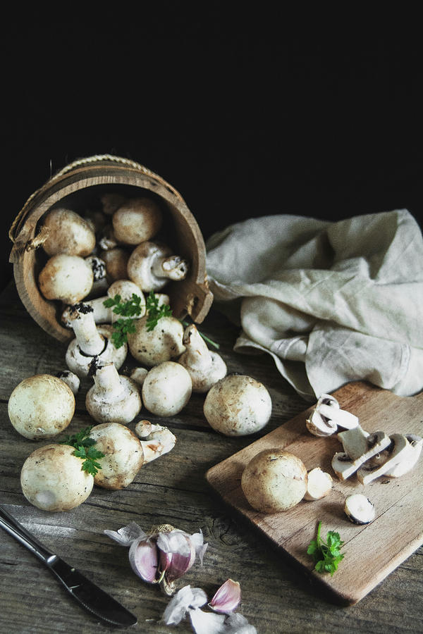 Mushrooms Champignon On The Wood Table Photograph by Marya Cerrone