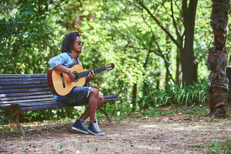 Elf Photograph - Musician Playing Guitar In A Nice Park. by Cavan Images