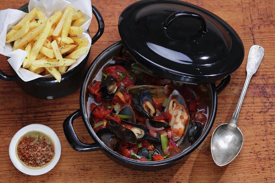 Mussel Stew With Chips On A Wooden Surface Photograph by Frank Weymann