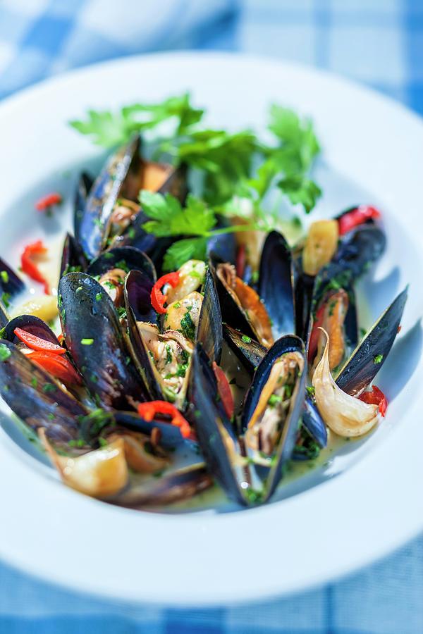 Mussels In A Wine Broth With Chillis And Garlic Photograph by Lukasz Zandecki