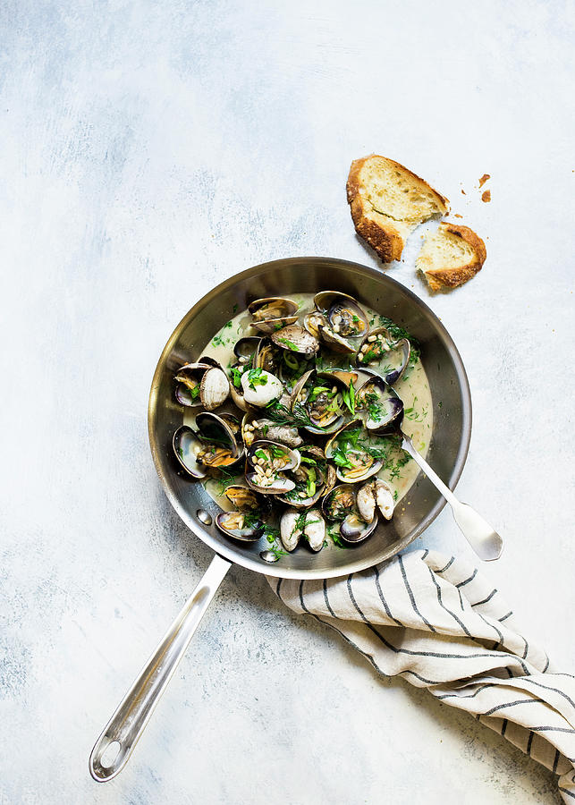 Mussels In Garlic And White Wine Sauce Served In A Pan With Bread Photograph by Lisa Rees