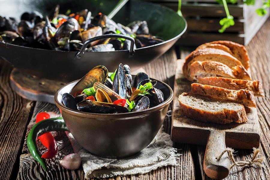 Mussels With Garlic And Chillis Served With Bread Photograph by Shaiith