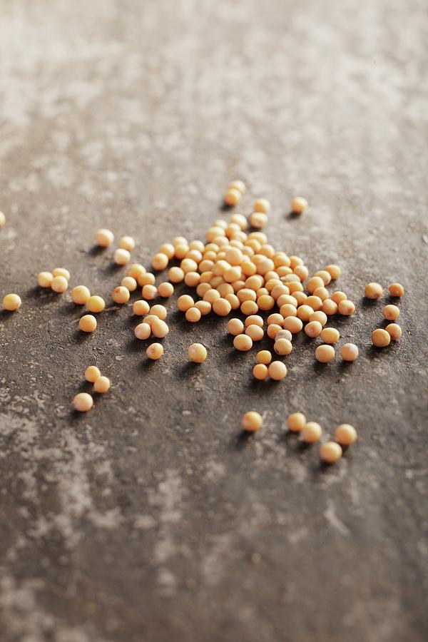 Mustard Seeds On A Grey Surface Photograph by Garten, Peter