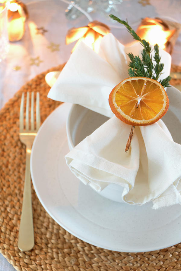 Napkin Decorated With Dried Orange Slice And Juniper Twig Photograph by Marij Hessel