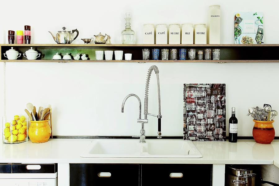 Narrow Shelf And Retro-look Kitchen Fronts As Structural Black Elements In White Kitchen Photograph by Pics On-line / June Tuesday