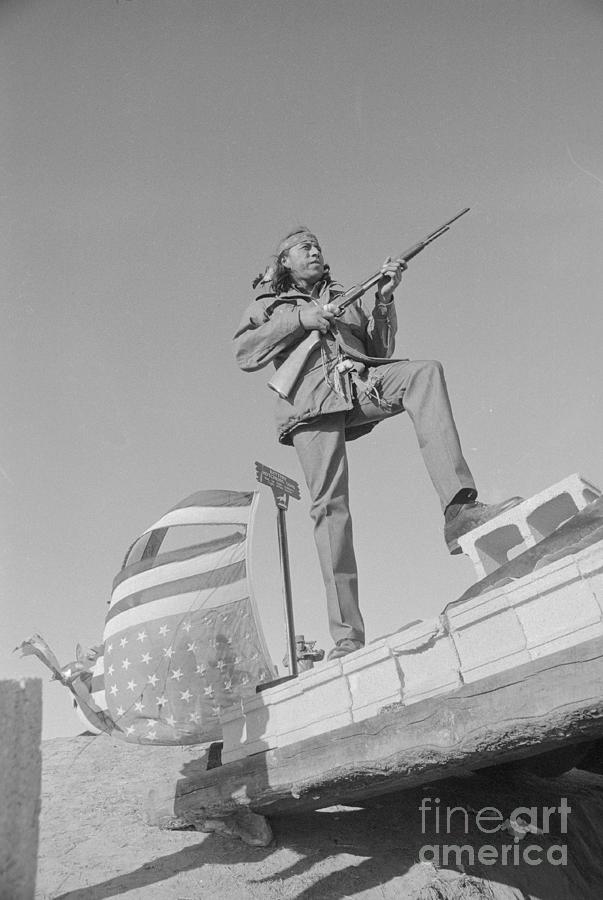 Native American With Gun At Wounded Knee Photograph by Bettmann