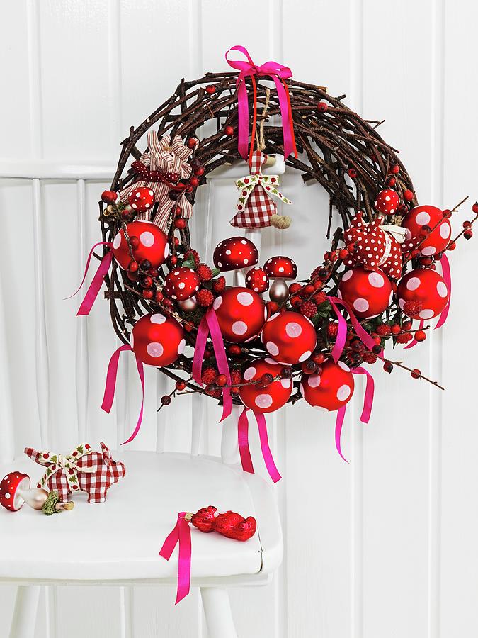 Natural Grass Wreath With Red And White Christmas Decorations On The Back Of A Chair Photograph by Biglife