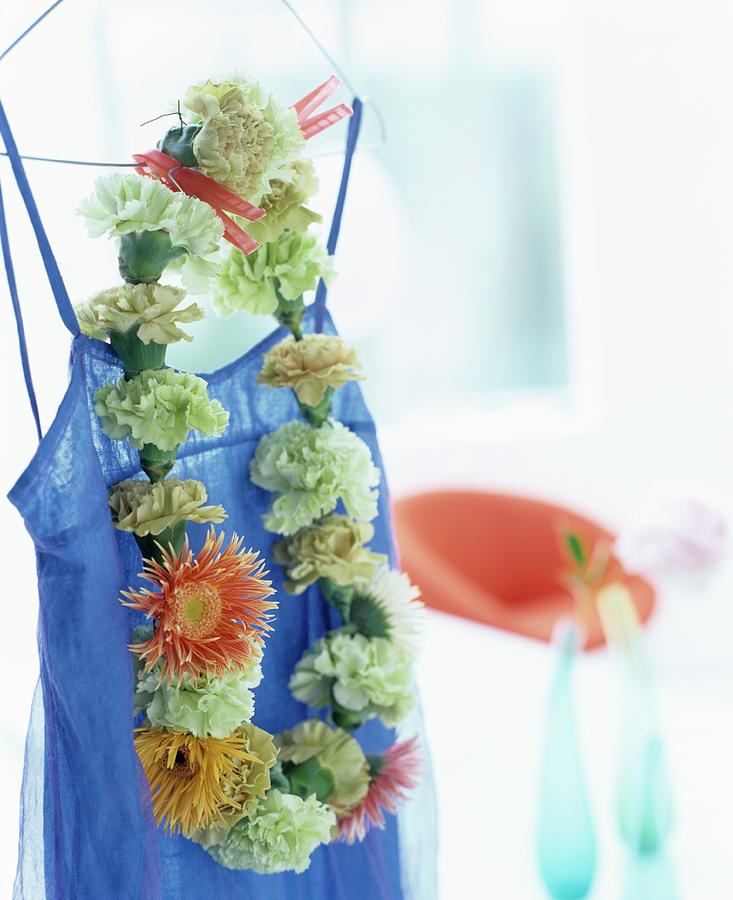 Flowers Still Life Photograph - Necklace Of Flowers Hung On Blue Dress by Matteo Manduzio