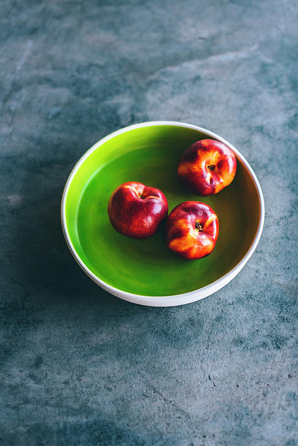 Nectarines In A Green Bowl Photograph by Hein Van Tonder