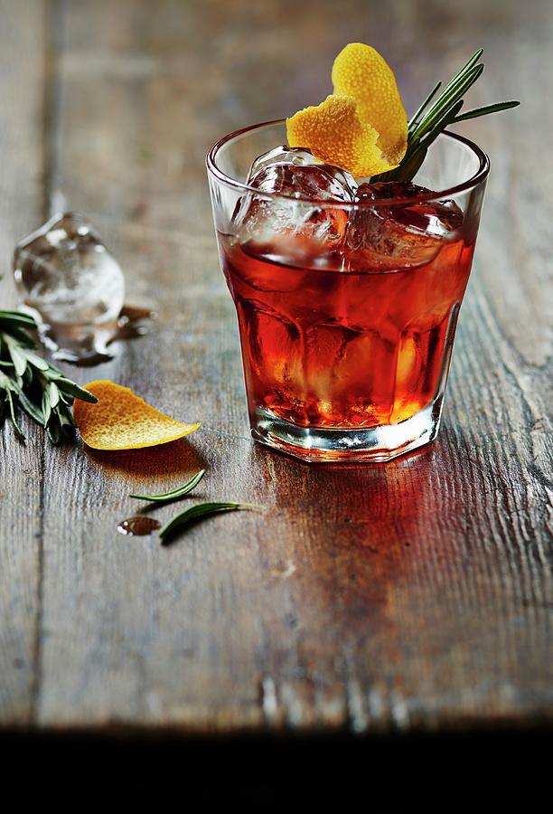 Negroni On Ice With Rosemary And Lemon Zest Photograph by Ria Osborne
