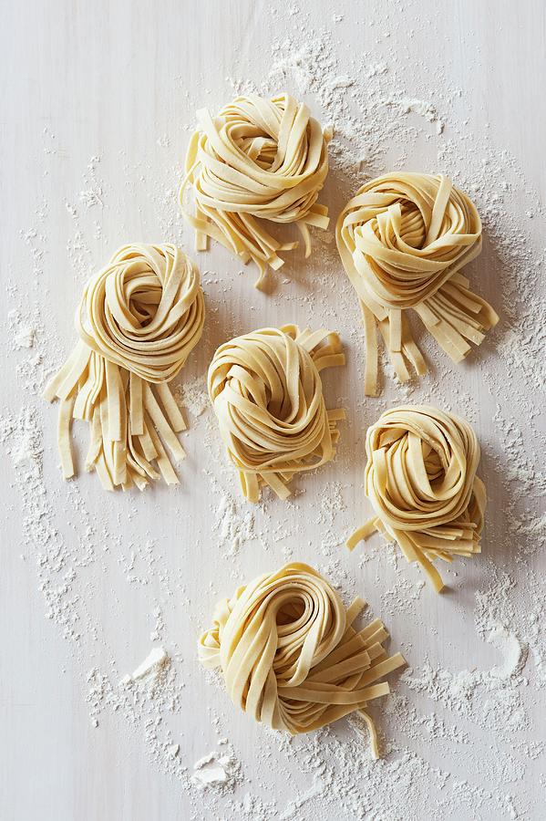 Nests Of Flat Noodles On A Floured Worktop view From Above Photograph by Mackevicius, Ashley