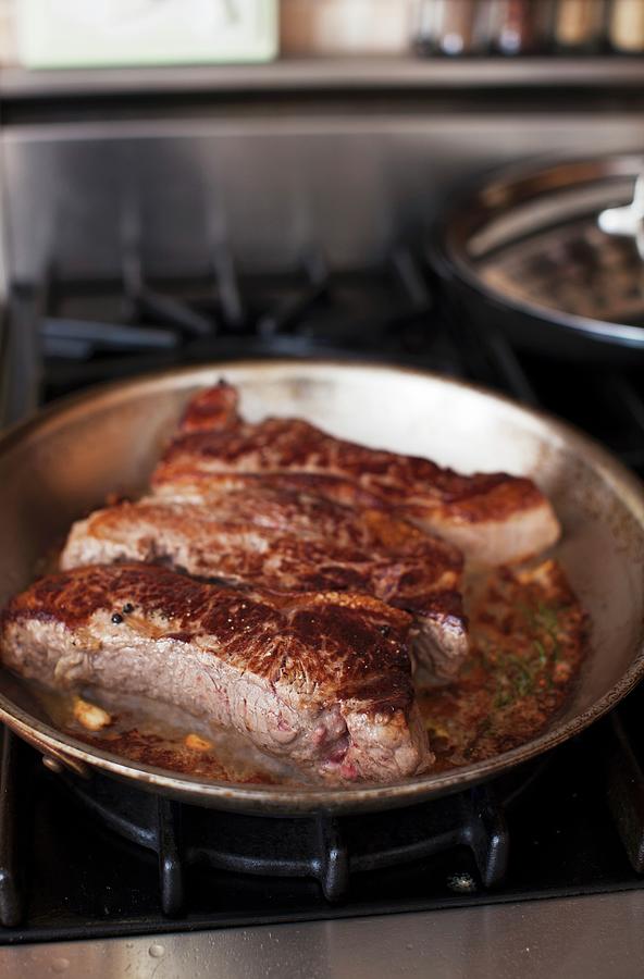 New York Strip Steaks In A Skillet Photograph by Yelena Strokin Fine