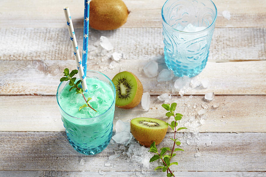 New Zealand Mocktail With Kiwi, Coconut Syrup, Pineapple And Lemon Juice And Blue Curacao Syrup Photograph by Teubner Foodfoto
