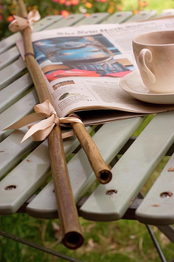 Newspaper In Bamboo Holders And Teacup Photograph by Michele Mulas
