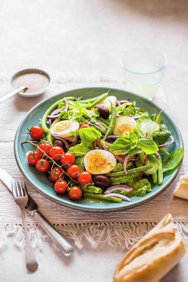 Nicoise Salad With Beans, Eggs, Anchovies, Olives And Tomatoes Photograph by Magdalena Hendey