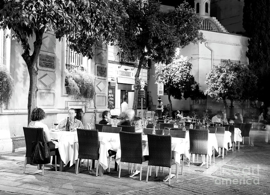 Night Dining at the Plaza Virgen de los Reyes in Seville Photograph by John Rizzuto