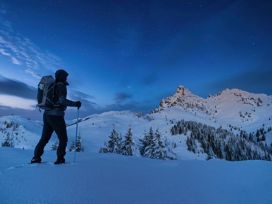Winter Photograph - Night Photo Climber Stands On Top by Daniel Chetroni