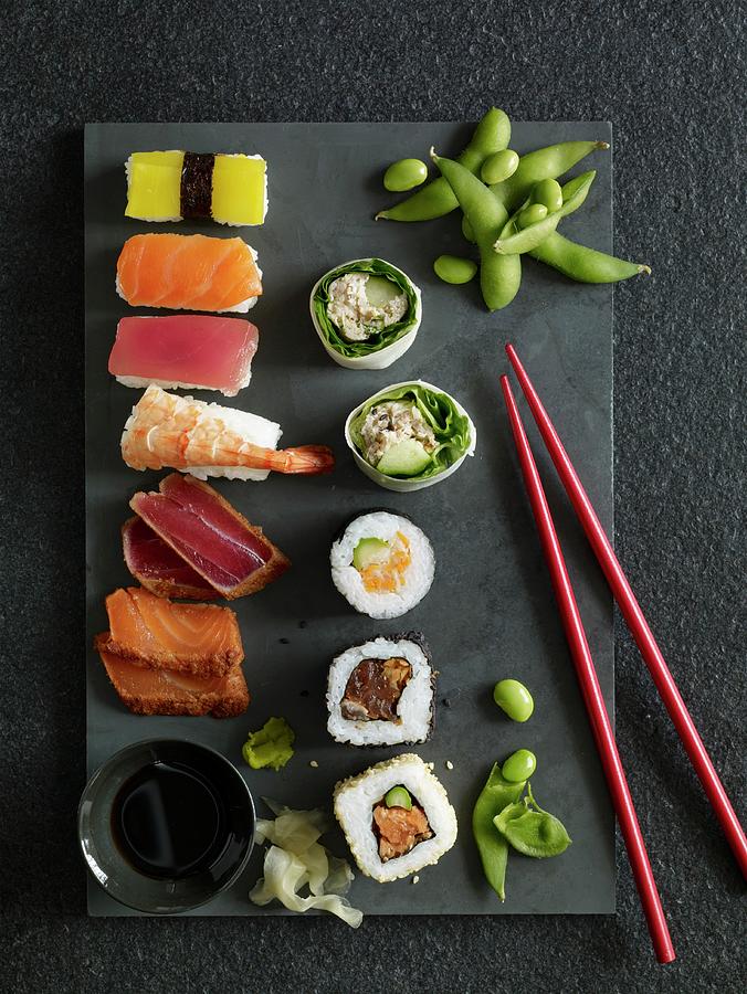 Nigiri Sushi, California Rolls, Maki Sushi And Sashimi On A Stone Platter Photograph by Jonathan Gregson