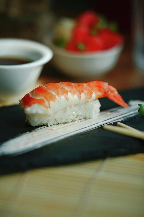 Nigiri Sushi With Shrimp On A Black Plate Photograph by Kuzmin5d