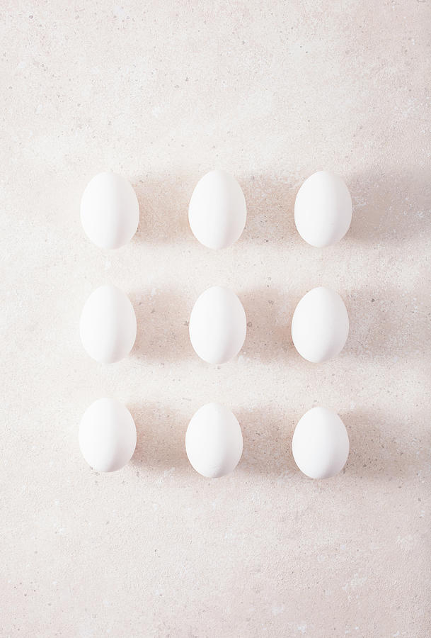 Nine White Hens Eggs In Rows On A Light Surface Photograph by Olga Miltsova