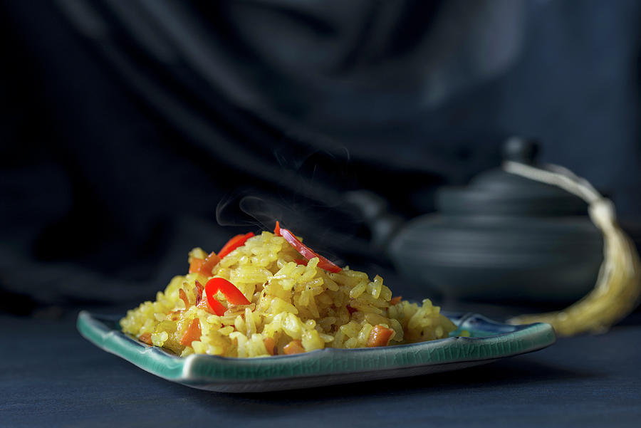 No-meat Pilaf Garnished With Red Chili Peppers On A Dark Blue Background Photograph by Albina Bougartchev