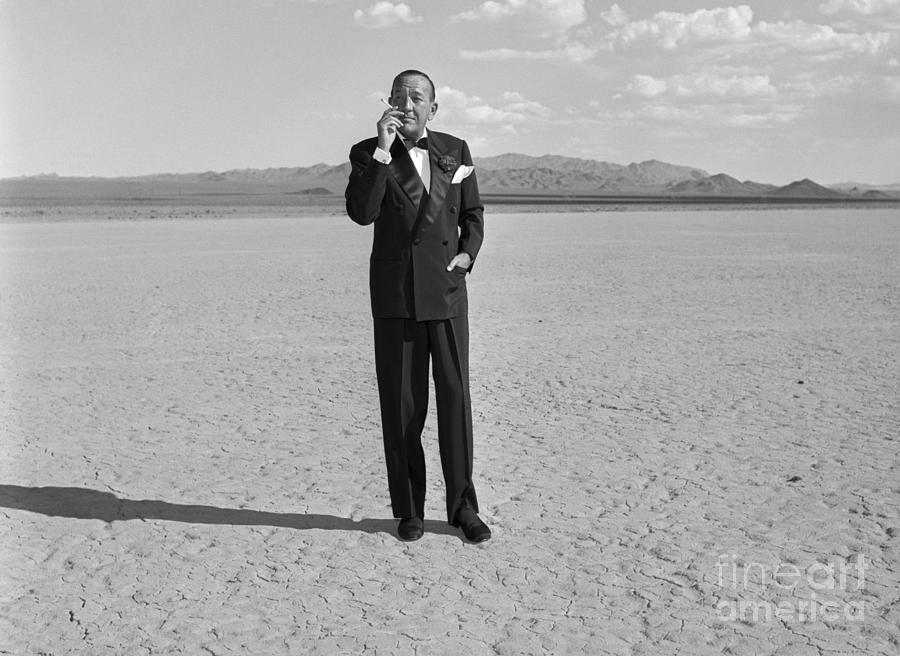 Celebrity Photograph - Noel Coward Smoking Cigarette In Desert by Bettmann