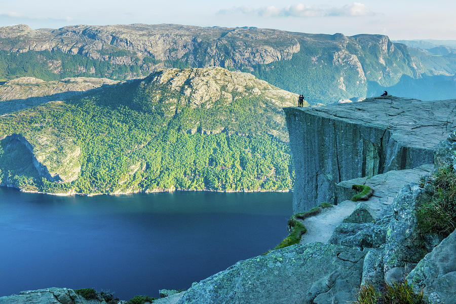 Image Digital Art - Norway, Rogaland, Preikestolen, Scandinavia, Couple At Preikestolen With The Lysefjord View (also Called Pulpit Rock Which Is A Cliff Over 600mt) Near Stavanger by Manfred Bortoli