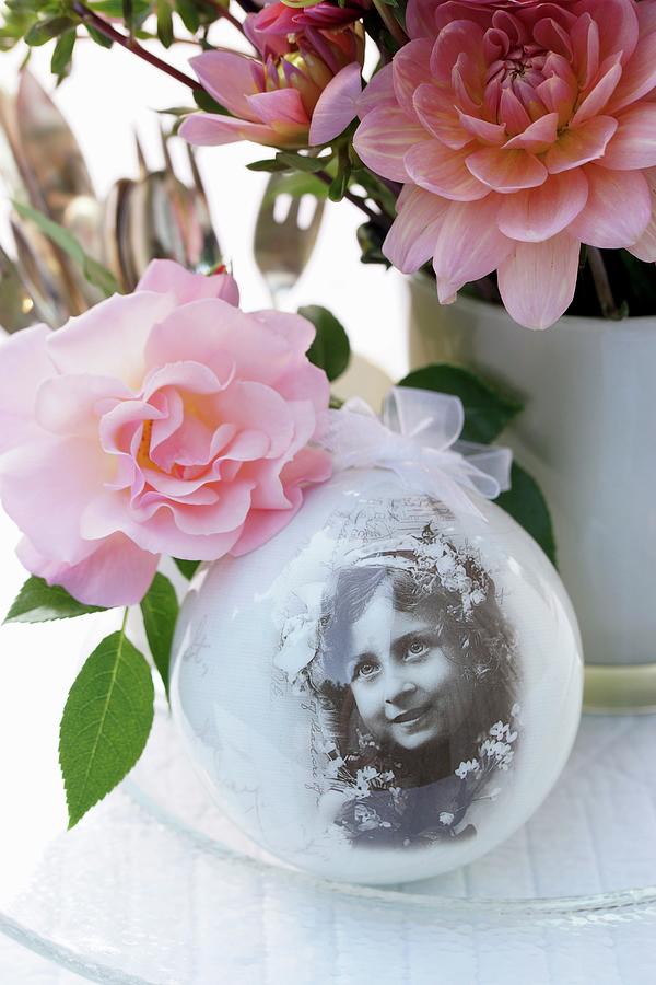 Nostalgic Arrangement Of Snow Globe And Roses On Table Photograph by Angelica Linnhoff