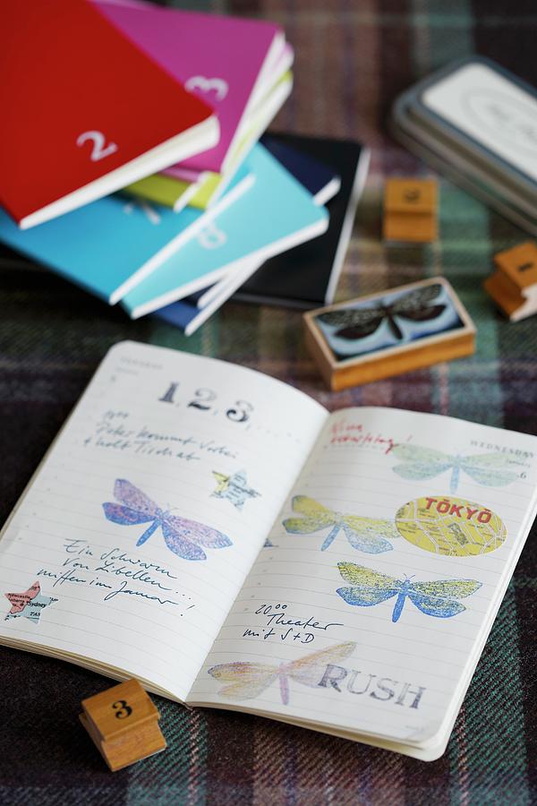 Nostalgic Wooden Stamps With Butterfly And Number Motifs, Various Books And Prints In Open Book Photograph by Alexandra Loock