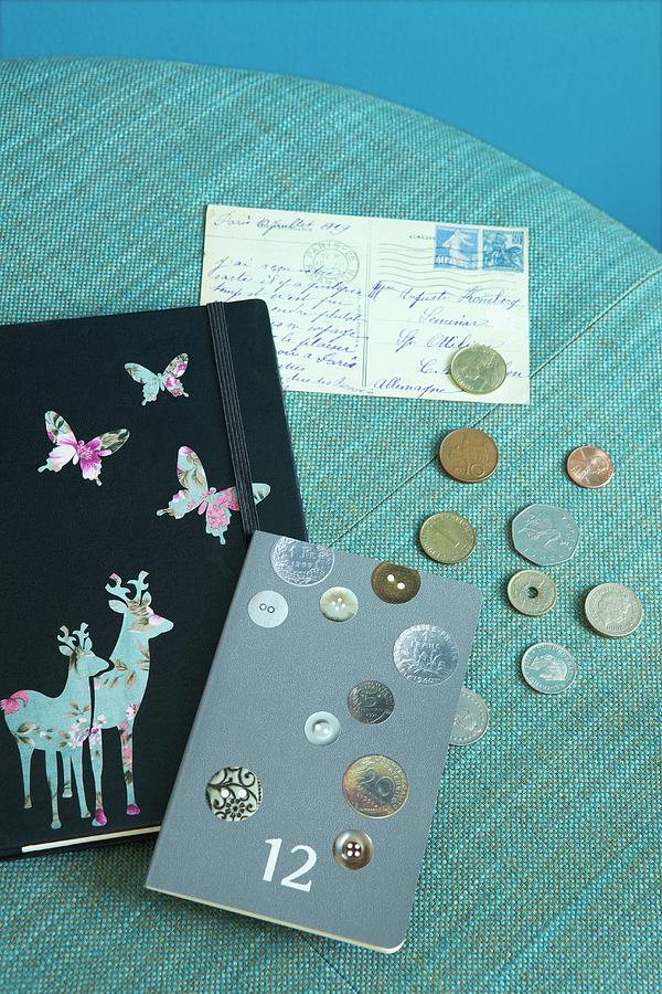 Nostalgically Decorated Note Books, Coin Collection And Old Postcard On Turquoise Surface Photograph by Alexandra Loock