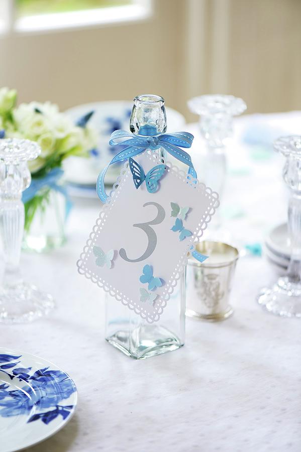 Number Tag Tied To Glass Bottle On Wedding Reception Table Photograph by Winfried Heinze