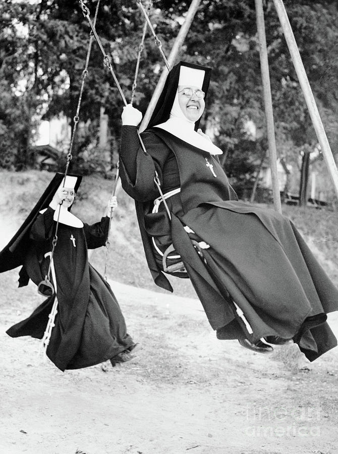 Nuns Swinging On Swing Set Photograph by Bettmann