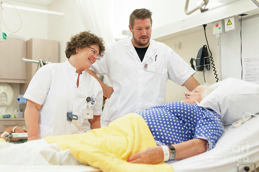 Nurse And Trainee Checking On A Patient Photograph By Arno Massee