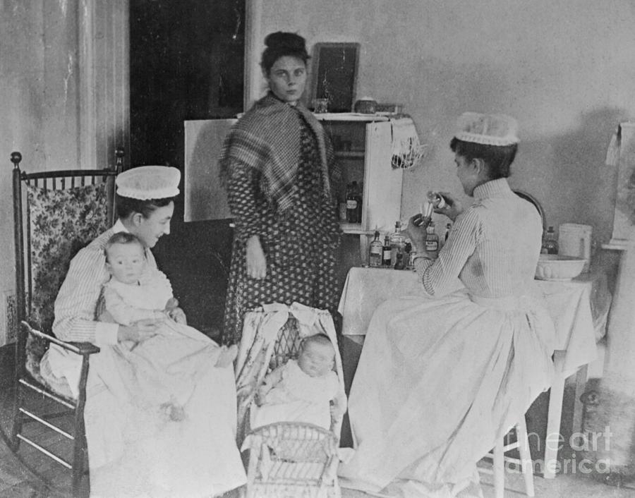 Nurses Caring For Children In Hospital Photograph by Bettmann