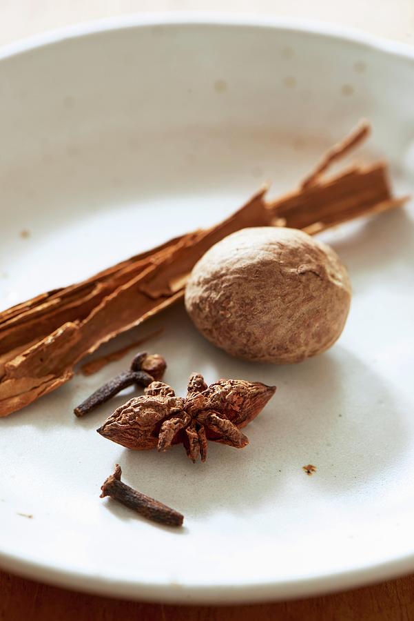 Nutmeg, Star Anise, Cloves And A Cinnamon Stick Photograph by Hugo Monteros