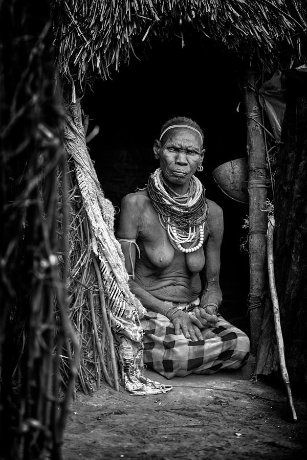 Nyangatom-tribe-old-woman-at-the-door-of-her-house Photograph by Veli Aydogdu