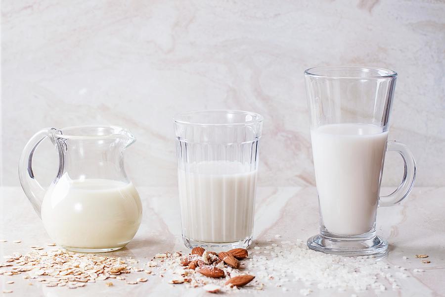 Oat Milk, Almond Milk And Rice Milk On A Marble Surface Photograph by Natasha Breen