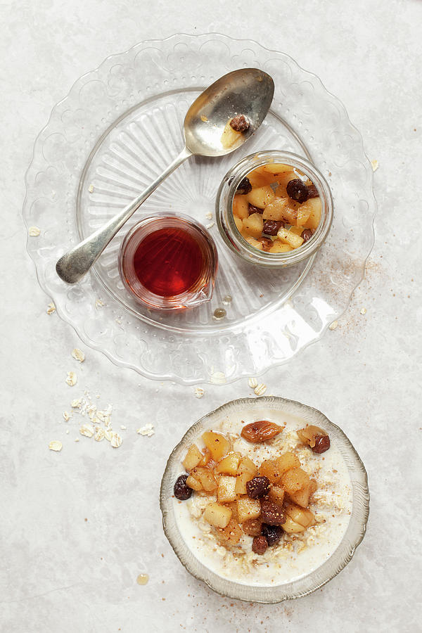 Oat Porridge Topped With Apple And Raisin Compote Photograph by Jane Saunders